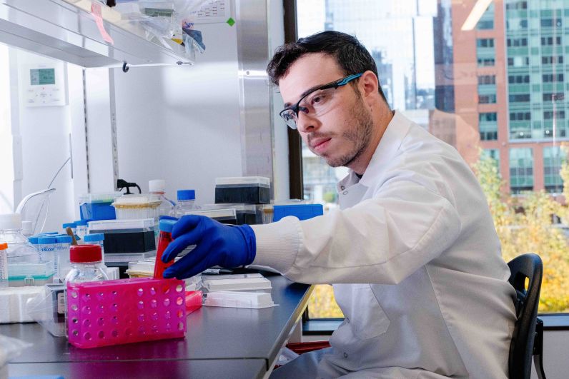 A scientist handling test tubes